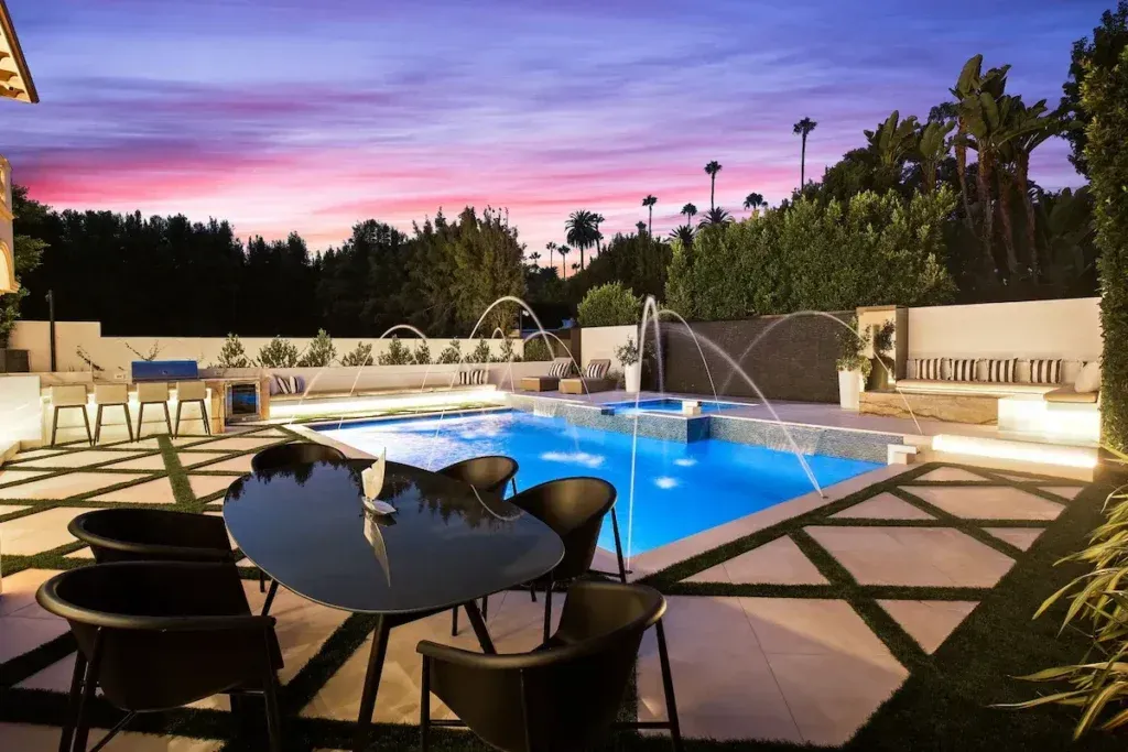 Alpine Mansion Outdoor Living space with pool at night